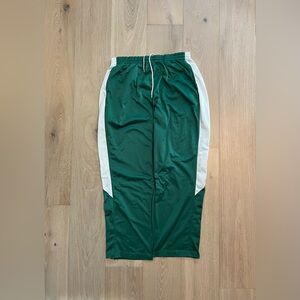 Dark green augusta athletic pants with white stripes and zipper leg-opening
